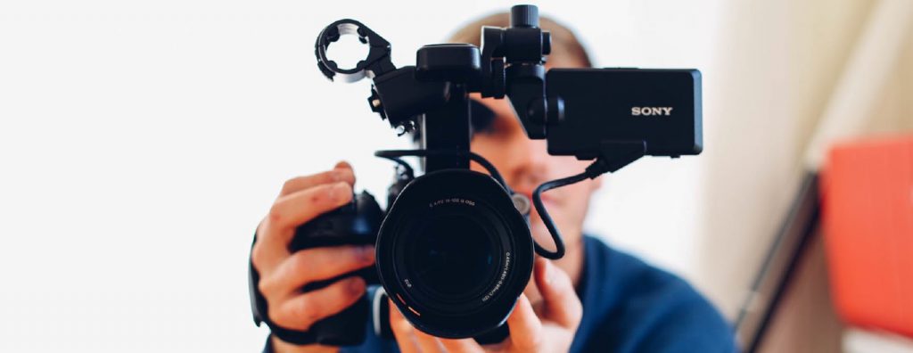 Man holding camera while filming