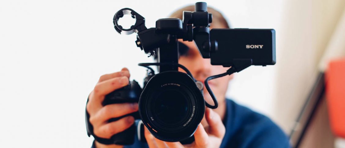 Man holding camera while filming