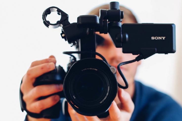 Man holding camera while filming