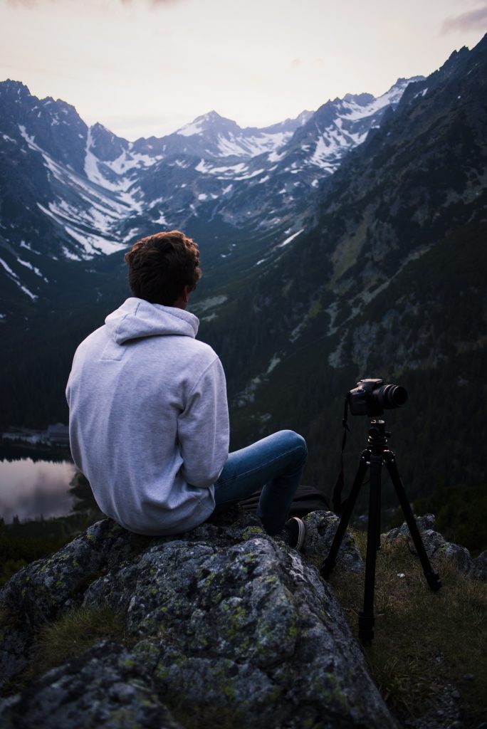 Man sitting with a tripod