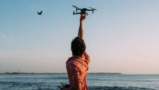 Person Flying Drone